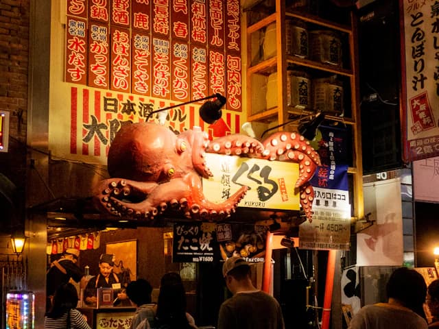 Neon-lit Dotonbori canal at night in Osaka
