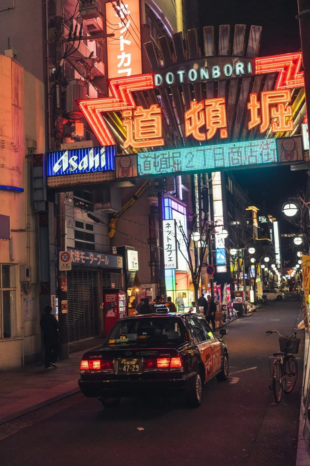 Neon-lit Dotonbori canal street at night in Osaka